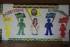 a bulletin board with some people holding flags and other items on it's side