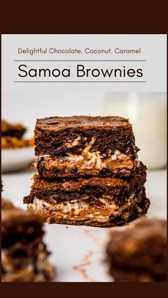 chocolate coconut caramel brownies stacked on top of each other in front of a glass of milk