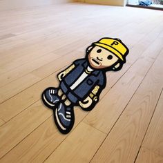 an image of a cartoon character on the floor with hard wood floors in the background