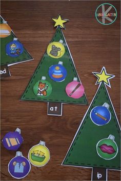 three christmas trees cut out from different shapes and sizes on a wooden table with matching stickers