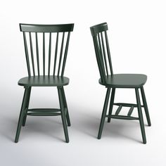 two green chairs sitting next to each other on a white surface and one has a black seat