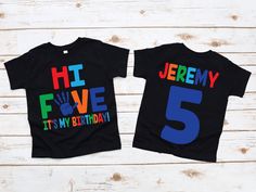 two children's t - shirts with the number five printed on them, one black and one blue