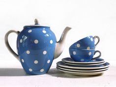 a blue tea set with white polka dots on it