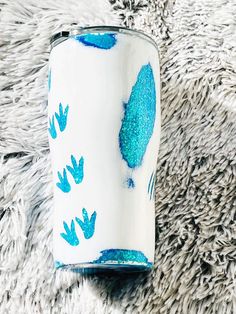 a blue and white cup sitting on top of a rug