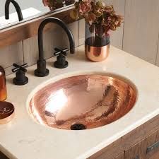 a bathroom sink sitting under a mirror next to a faucet and soap dispenser