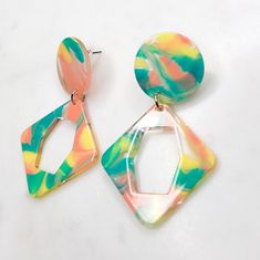 🤎 This listing is for a pair of geometric multicolor swirled resin dangle drop earrings. 🤎 Earrings are a beautiful mix of marbled aqua, yellow and a pinkish coral shade against a clear background. They consist of a diamond shaped resin piece attached to a round matching connector.  🤎 Earrings are handmade and constructed with hypoallergenic materials free of lead and nickel. 🤎 Earrings are just under 2 inches long. 🤎 Each order is prepared and wrapped with love, just for you. 🤎 Care:  To care for your jewelry, simply wipe down with a slightly damp soft cloth. Store in pouch when not in use. 🤎 Thank you for checking out Calliope's Utopia! If you are happy with your purchase, please consider leaving a 5 star rating. Trendy Multicolor Dangle Earrings, Trendy Multicolor Drop Earrings, Trendy Multicolor Hypoallergenic Earrings, Trendy Multicolor Jewelry With Matching Earrings, Modern Multicolor Dangle Jewelry, Trendy Colorful Dangle Jewelry, Summer Hypoallergenic Multicolor Jewelry, Summer Multicolor Hypoallergenic Earrings, Modern Multicolor Dangle Earrings