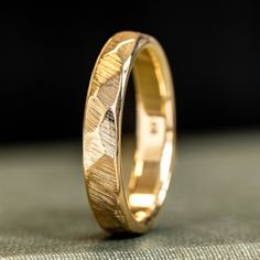 Illuminate your love story with "The Luna" hammered gold wedding band. Reflecting the moon's timeless allure, its hammered gold surface will always remind you of the celestial bond you share. Just as the moon orbits the Earth, let this ring be a symbol of your unending love.
The Luna Yellow Gold Ring Features:

SCS certified 100% recycled gold ring base
Hand-faceted solid gold ring

Fit: Comfort Fit

Available in: 10K, 14K or 18K Yellow Gold 

Available Widths: 3mm, 4mm, 5mm
*Free ring size-from-home kit available*
Handcrafted in North Carolina, USA
Made to order just for you
Limited Lifetime Warranty


Faceted Solid Yellow Gold Wedding Band
Every Luna Gold Ring is handcrafted in-house by our skilled crafters. We craft each one of a kind Luna by placing several faceted sections along the s Hammered Gold Wedding Band, Recycled Gold Ring, Rustic Wedding Bands, Yellow Gold Wedding Band, Hammered Gold, Solid Gold Rings, Ring Fit, Recycled Gold, Gold Wedding Band