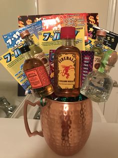 a copper mug filled with liquor bottles and candy