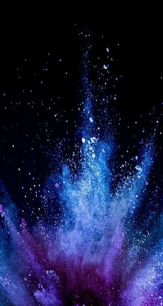 blue and purple powder exploding in the dark