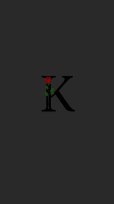 the letter k with a rose in it is black and red, against a dark background