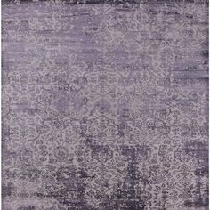 an area rug with purple and white colors