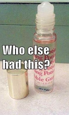 an empty glass bottle sitting on top of a table next to a small metal container