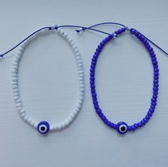 Seed bead anklet with an evil eye bead. anklet length is adjustable with a sliding knot closure. Wearing the evil eye protects you from bad luck, evil spirits, and ill intentions from others that could have a negative effect on your life or well-being. Evil Eye Bracelets Diy, White Beaded Bracelets With Adjustable Length, White Evil Eye Beaded Bracelets For Festivals, White Beaded Bracelets With Sliding Knot For Festival, White Sliding Knot Beaded Bracelets For Festivals, White Evil Eye Round Beads Friendship Bracelets, White Evil Eye Bracelets For Festival, Festival White Evil Eye Bracelets, Spiritual White Friendship Bracelets For Festival