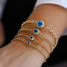 This 14k gold dainty evil eye bracelet is a beautifully crafted piece, perfect as a daily wear protection symbol. Designed with a blue evil eye charm on a rolo chain, this delicate bracelet offers timeless elegance and protection. The evil eye bracelet is a thoughtful gift for her--ideal for occasions like Valentine's Day, Christmas, or as a bridesmaid gift. Featuring a 14k solid gold chain with an adjustable length, it's both stylish and meaningful. The evil eye jewelry is a powerful talisman, Symbol Jewelry, Thoughtful Gifts For Her, Good Luck Gifts, Gold Armband, Jewelry Minimalist, Symbolic Jewelry, Solid Gold Chains, Blue Evil Eye, Ruby Jewelry