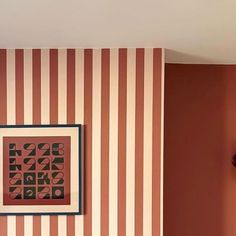 an orange and white striped wall in a living room