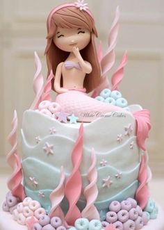 a little mermaid cake with pink and blue icing