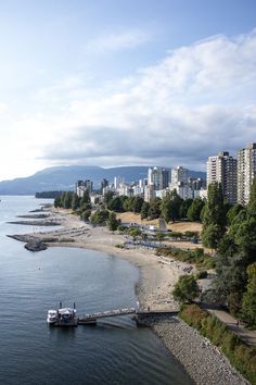 an aerial view of a city and the water with a boat in the foreground