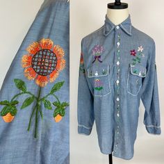 Groovy 1970s hand embroidered BIG MAC denim chambray hippie shirt. Lightweight, super soft cotton blend. Button front. Men's workshirt altered for a womens fit.  SIZE: Modern Women's Small CONDITION: Very good! Light general wear. Some distressing to chain stitch embroidery at shoulder. Bust: 39" Waist: 36" Hips: 38"  Length: 30" Shoulder to shoulder: 16" across Sleeve length: 23" Bohemian Embroidered Button-up Shirt, Bohemian Embroidered Button-up Tops, Spring Bohemian Button-up Shirt, Bohemian Cotton Button-up Shirt, Bohemian Shirt With Button Closure For Spring, Bohemian Spring Shirt With Button Closure, Spring Bohemian Shirt With Button Closure, Bohemian Fitted Shirt With Buttons, Bohemian Embroidered Denim Tops