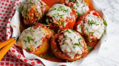 a white bowl filled with meatballs covered in sauce