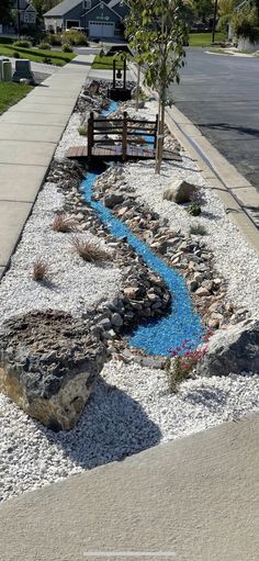 a small stream running through a rock garden