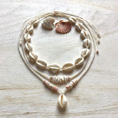 Necklaces are made of natural cowrie shells (16 - 20 mm, single shell 20 - 24 mm), milky white or alabaster rainbow and pearl white original Czech glass beads (2.9 / 4.1 mm Rocailles Preciosa), shell 'puka' beads (5-10 mm) and waxed polyester cord (original Linhasita 1 mm).  They are robust and fully waterproof.  The length is adjustable and should fit all neck sizes (minimum length is 32 cm =12,6 inches and maximum 66 cm = 26 inches).  If you have any questions/wishes, please don't hesitate to Cheap Shell Beaded Necklaces With Round Beads, Cheap Bohemian Shell Beaded Necklaces, Adjustable White Cowrie Shell Necklace, White Shell Jewelry With Ocean-inspired Style, White Shell-shaped Shell Jewelry, Adjustable White Shell Jewelry, Natural Cowrie Shell Jewelry For Gift, Natural Cowrie Shell Jewelry As Gift, Natural Color Cowrie Shell Jewelry Gift