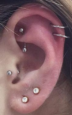 a woman with three piercings on her ear