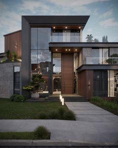 a modern house is shown at night with its lights on and the front door lit up