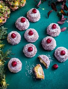 an image of pastries with cherries and powdered sugar on a green plate