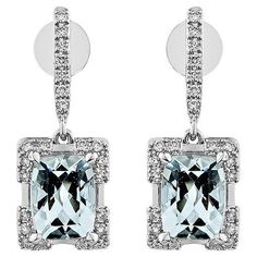 This collection features an array of Aquamarines with an icy blue hue that is as cool as it gets! Accented with Diamonds these Drop Earrings are made in White Gold and present a classic yet elegant look. Aquamarine Drop Earring in 18Karat White Gold with White Diamond. Aquamarine: 2.418 carat, 8X6mm size, Cushion shape White Diamond: 0.314 carat, 1.20mm size, round shape, G color, VS clarity. Gold:4.293, 18Karat White Gold. Butterfly Pin and Push Back. E549 Butterfly Pin, Naha, Icy Blue, Aqua Marine, Gold Butterfly, Drop Earring, Blue Hues, White Diamond, Aquamarine