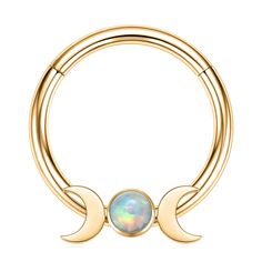 a gold nose ring with an opal in the middle and two crescents around it