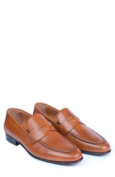 Handmade of smooth leather, this moc-toe dress shoe with a classic penny loafer silhouette offers a sophisticated, elegant look. Leather upper and lining/synthetic sole Made in Turkey Penny Loafers Men, Classic Slippers, Elegant Look, Flip Flop Slippers, Penny Loafer, Ugg Classic, Dress Shoe, Denim Branding, Sweaters And Leggings