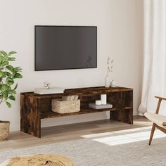 a living room with a large flat screen tv mounted on the wall above a wooden table