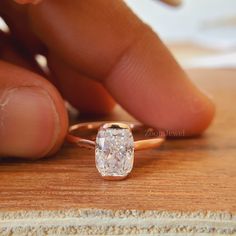 a close up of a person's hand touching a diamond