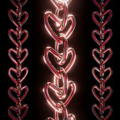 some red and green lights that are in the shape of heart shaped chains on a black background