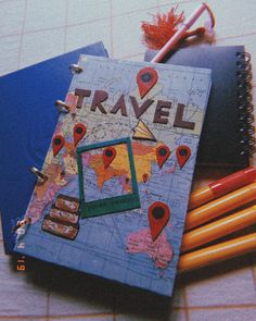 there is a notebook with the word travel on it