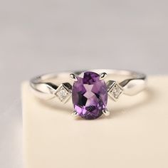 All HANDMADE ITEMS SHIP IN APPROX 8 DAYS Main Stone: Real natural amethyst Main Stone Size: Oval cut 6 mm x 8 mm Main Stone Weight: 1.19 carat Side Stone: CZ Height From The Ring Setting Bottom(to gemstone top): about 5.24 mm Width of Ring band Measure: gradually varied,about 2.14 to 2.99 mm Material: 925 Sterling Silver/14K White Gold/14K Yellow Gold/14k Rose Gold Engraved: Available For FreeNo more than 13 letters) Customized:Of course! Tell me what you want Includes With Order: All of my stor Purple Amethyst Diamond Ring, Birthstone, Purple Amethyst Diamond Ring Birthstone, Purple Diamond Amethyst Birthstone Ring, Purple Amethyst Diamond Birthstone Ring, Purple Amethyst Birthstone Ring With Diamond, Oval Amethyst Promise Ring In Purple, Oval Purple Amethyst Promise Ring, Purple Diamond Solitaire Amethyst Ring, Amethyst Birthstone Ring In White Gold