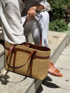 Handbag Jute tote with leather details, the best accessory for this summer.   Leather shoulder strap.  Inside pocket.   Organic and metal-free design.  Dimensions: Length 46cm, height 26cm, 31cm with handles, width 12cm.  Magnet closure.  Bag with excellent finishes that will allow you to carry everything you need on your summer days or even, if you need it, a computer or iPad. Its long handles allow you to hang it on your shoulder so you can keep your hands free. Its lightness and design will Casual Straw Bag With Detachable Handle For Travel, Casual Everyday Straw Bag With Detachable Handle, Leather Handled Satchel Travel Bag For Shopping, Satchel Travel Bag With Leather Handles For Shopping, Summer Satchel With Double Handle For On-the-go, Leather Handle Satchel Travel Bag For Shopping, Everyday Straw Bag With Top Handle And Adjustable Strap, Casual Travel Bag With Detachable Handle, Elegant Straw Tote Bag For On-the-go