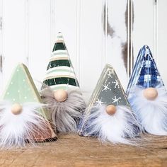 three small gnome hats sitting on top of a wooden table