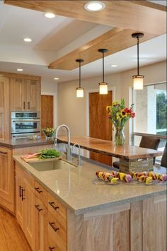 a large kitchen with wooden cabinets and an island