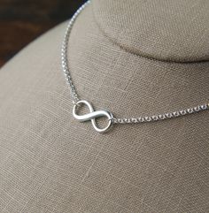 Infinity symbol necklace in sterling silver, sturdy, infinity necklace, silver infinity, eternity necklace, mother's day A sterling silver infinity symbol with raised edges measures 0.37 x 0.75 inches (9.5 x 19mm) and is attached to a sterling silver rolo chain that can be any length up to 22 inches. It is secured with a sterling silver lobster claw clasp. Your purchase will arrive in a jewelry box ready for gift giving or as a gift for yourself! Enter my shop here: jersey608jewelry.etsy.com Tha Minimalist Infinity Necklace In White Gold, Minimalist White Gold Infinity Necklace, Silver Infinity Dainty Necklace, Silver Infinity Necklace In Dainty Style, Sterling Silver Infinity Necklace With Adjustable Chain, Silver Dainty Infinity Necklace, Silver Infinity Jewelry, Dainty Silver Infinity Necklace, Simple Infinity Jewelry For Anniversary