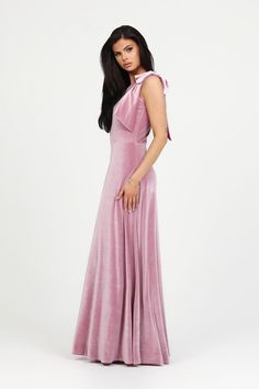 a woman in a pink dress posing for the camera