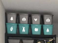 the shelves are filled with plastic buckets and other items for halloween decorations on them