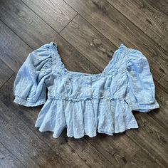 Free People Leave It To Me Smocked Babydoll Top, Cropped. Exaggerated Sleeves, Square Neckline With Button Front Details. Size Small In Baby Blue Color New Without Tags. Never Worn. No Flaws. Spring Smocked Bodice Button-up Top, Casual Button-up Top With Smocked Bodice, Cute Blue Puff Sleeve Blouse, Light Wash Cotton Blouse With Ruffles, Blue Cotton Smocked Top, Cute Cotton Tops With Smocked Bodice, Light Wash Fitted Ruffle Top, Cute Fitted Light Blue Blouse, Fitted Blue Cotton Smocked Top