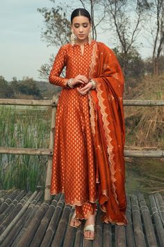 Burnt orange vegan silk anarkali with floral weaving pattern. Comes with pant and a dupatta. - Aza Fashions Red Duppata Contrast Suit, White Anarkali Dress With Red Dupatta, Anarkali Suits Silk, Anarkali Silk Dress, Anarkali Silk Suits, Party Wear Anarkali Suits, Orange Dupatta, Suit Set Design, A Line Salwar Suits