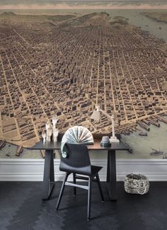 a large city wallpaper mural in an office with a desk and chair next to it