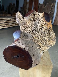 a piece of wood that has been carved to look like a bear's head