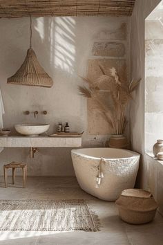 a large white bath tub sitting next to a sink in a bathroom under a window