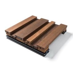 three pieces of wood sitting on top of each other in front of a white background