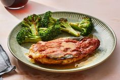 a plate with some meat and broccoli on it