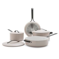 an assortment of pots and pans on a white background, including one with a frying pan